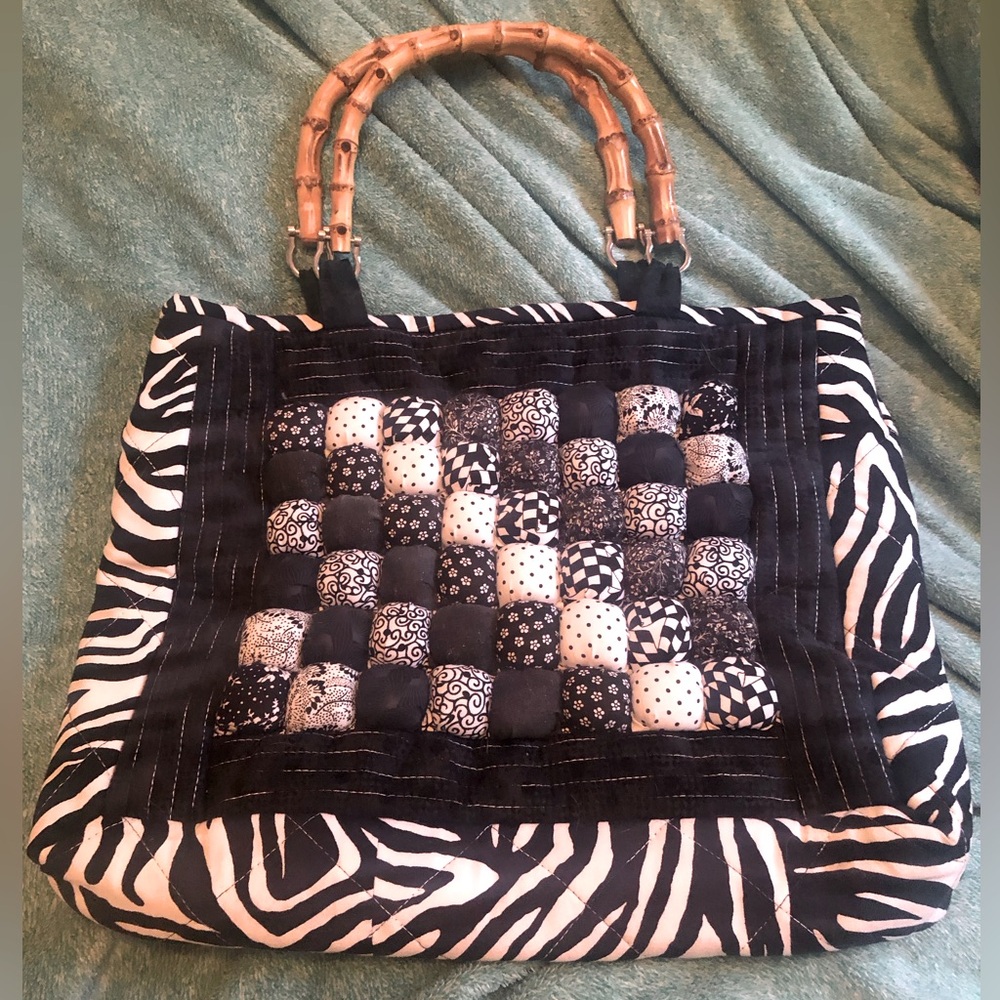 Vintage and unique, quilted black and white bag with wooden handles